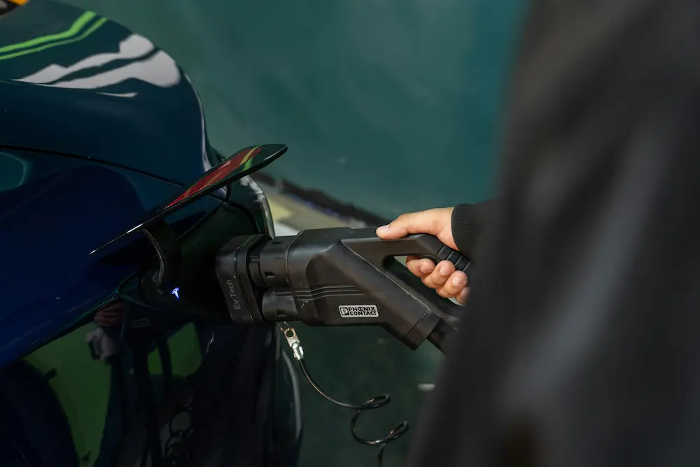 A man charging his ev car in Kerala